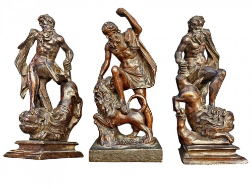 Three carved fruitwood sculptures depicting Hercules taming the lion