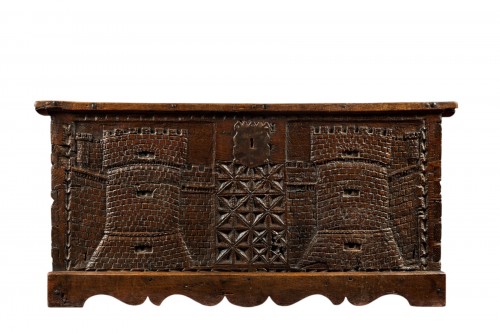 Wooden chest carved with two crenellated towers