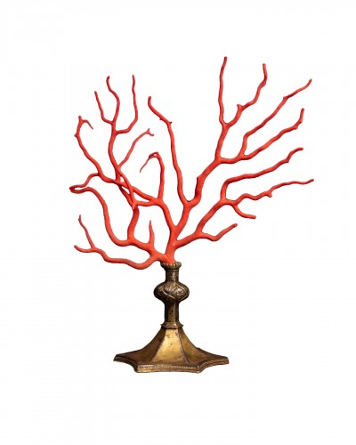 Red coral branch set on a Gothic brass base