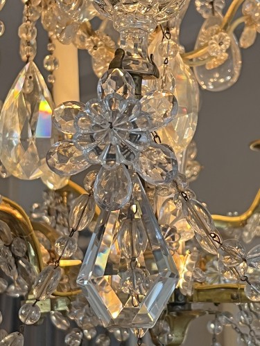 Lighting  - A French ormolu and cut crystal glass six-light chandelier