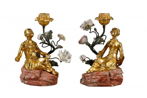 Pair of so-called “magots” torches  in gilded bronze and porcelain