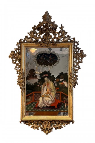 Mirror in gilded wood with carved top and painting of an oriental figure