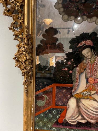 Mirror in gilded wood with carved top and painting of an oriental figure - 