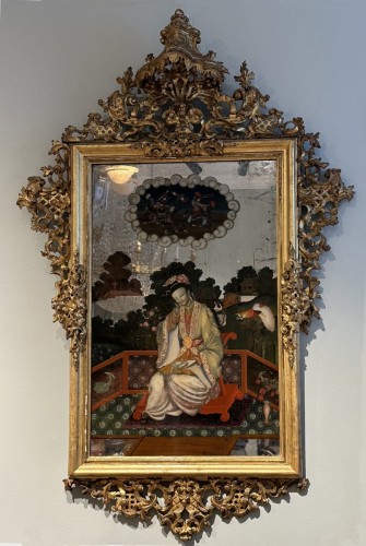 Mirror in gilded wood with carved top and painting of an oriental figure - 