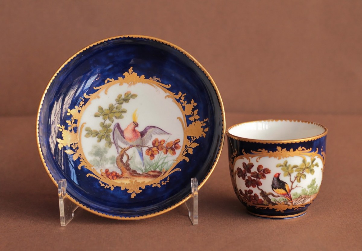 Cup and saucer in soft Sèvres porcelain, lapis blue background 