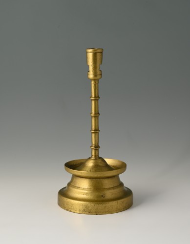 Lighting  - Very fine brass four-knop circular-based candlestick.