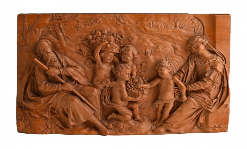 A fruitwood relief Depicting Joseph, Mary, Jesus and three cherubs bringing