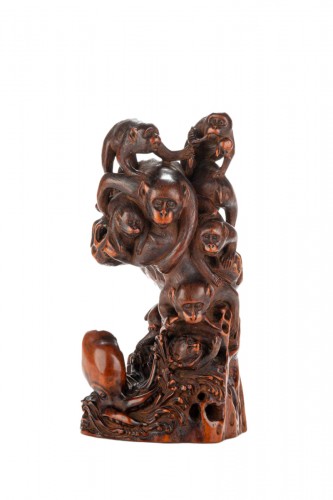 A Boxwood Okimono Depicting A Group Of Monkeys With An Octopus