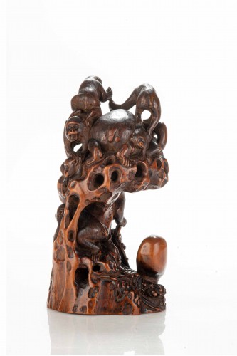 Asian Works of Art  - A Boxwood Okimono Depicting A Group Of Monkeys With An Octopus