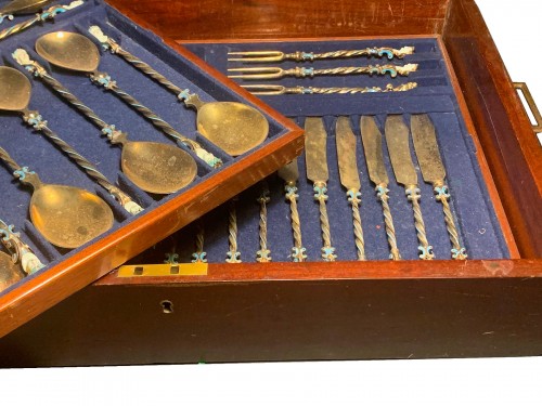 A silver-gilt and enamel cutlery service 