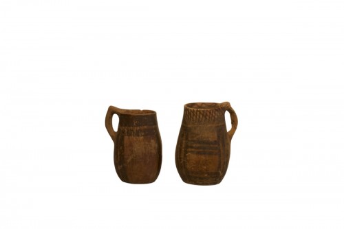 A pair of Neolithic earthenware handled cups in a "beer mug" form